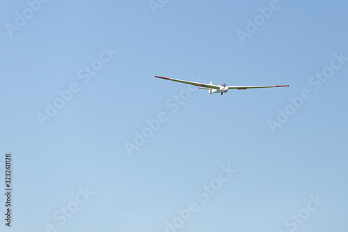 Flying glider in the blue sky