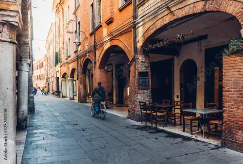Fototapeta Naklejka Na Ścianę i Meble -  Cozy narrow street in Ferrara, Emilia-Romagna, Italy. Ferrara is capital of the Province of Ferrara
