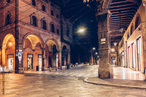 Fototapeta Naklejka Na Ścianę i Meble -  Old narrow street in Bologna, Emilia Romagna, Italy. Architecture and landmark of Bologna. Night cityscape of Bologna.