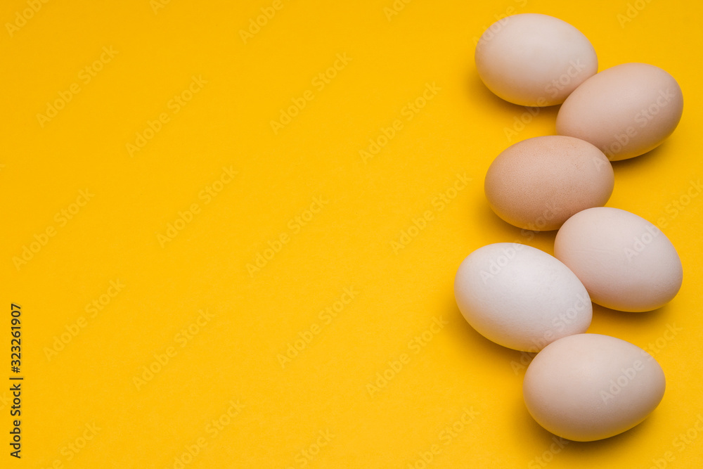 natural ecological eggs on yellow background in a row with copyspace natural ecological eggs on yellow background in a row with copyspace