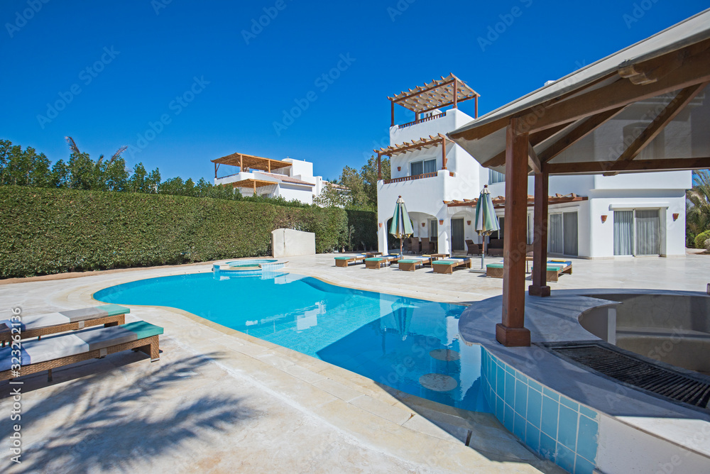 Fototapeta premium Swimming pool at at luxury tropical holiday villa resort