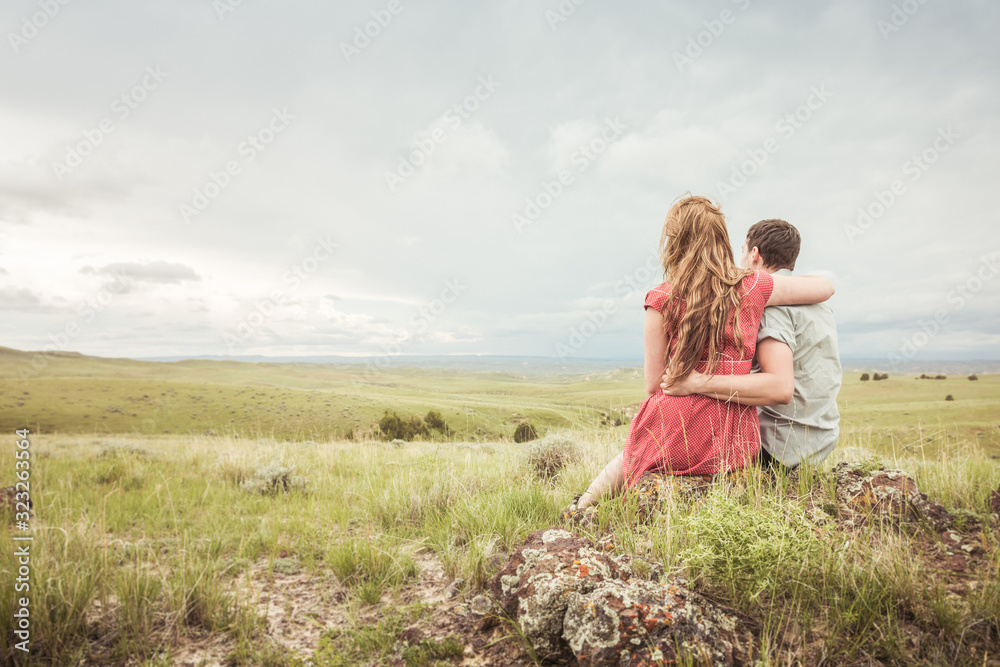 Couple hugging after picnic in a rural prairie setting. Cody, Wyoming, USA Couple hugging after picnic in a rural prairie setting. Cody, Wyoming, USA
