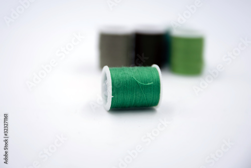 In selective focus of green thread put on white background,show texture,for needle work