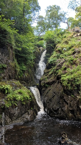 Green waterfall in forest, waterfalls in lake district