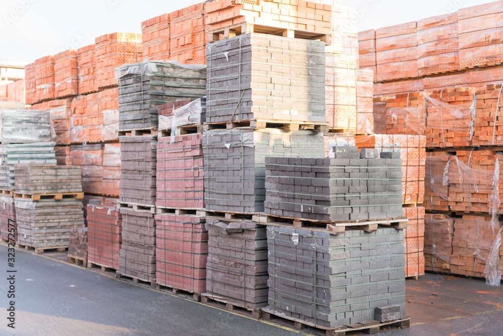 pallets with bricks in the building store. Racks with brick. Masonry, stonework. Several pallets with concrete brick stacked on top of each other in depot. new bricks on pallets pallets with bricks in the building store. Racks with brick. Masonry, stonework. Several pallets with concrete brick stacked on top of each other in depot. new bricks on pallets