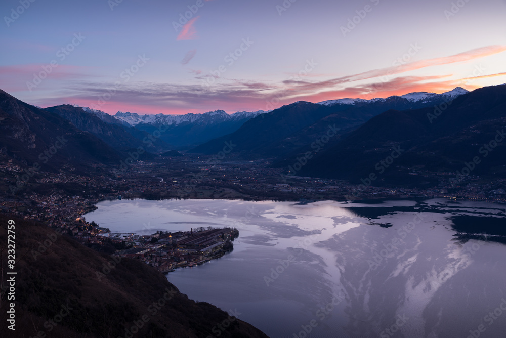 Romantic scenic view of the sunrise at Iseo Lake with alps in the background