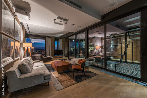 Interior of a living room in a luxury penthouse apartment in the evening