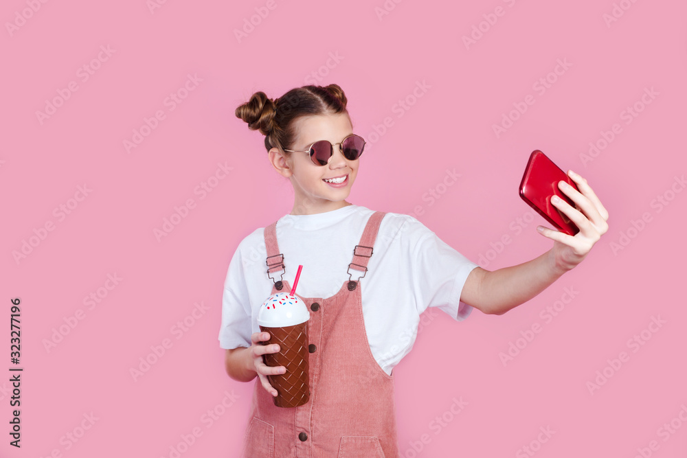 trendy stylish beautiful girl in white t-shirt and sunglasses while she makes selfie photo on her smartphone trendy stylish beautiful girl in white t-shirt and sunglasses while she makes selfie photo on her smartphone