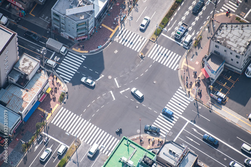 Tokyo, Japan - March 27 2019: People passing the street crossing in Sumida district, Tokyo. Crosswalk. Intersection in Tokyo