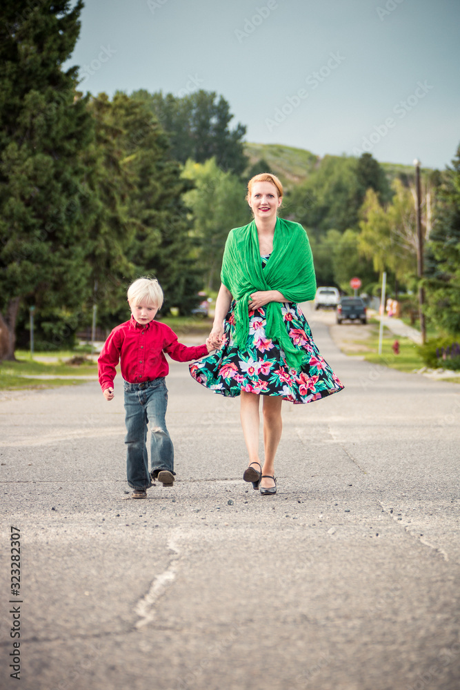 Woman with son walking down street of small town. Red Lodge, Montana, USA Woman with son walking down street of small town. Red Lodge, Montana, USA