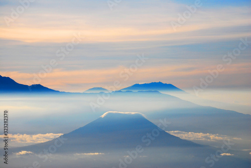 Rinjani Mountain Landscape and Pink sky in the morning with fog and misty around the Valley. View from Bromo Mountain at Bromo tengger semeru national park , Indonesia - nature backdrop