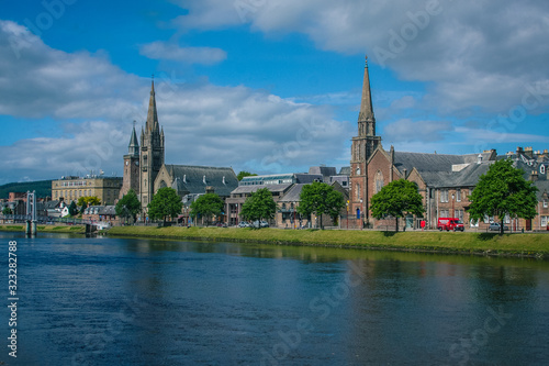 Cityscape of Inverness over river Ness, Old High Church and Free Church are visible on a sunny day. © Anze