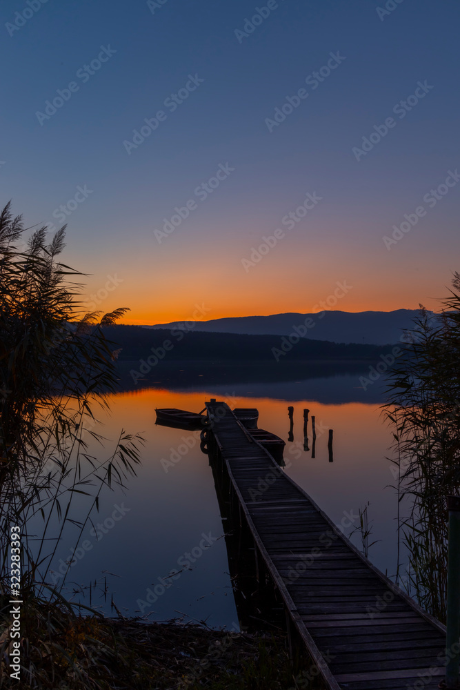 Fototapeta premium fishing boat at pier on Jenoi pond near Diosjeno, Northern Hungary