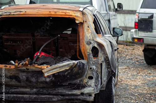 burnt car parked in a lot