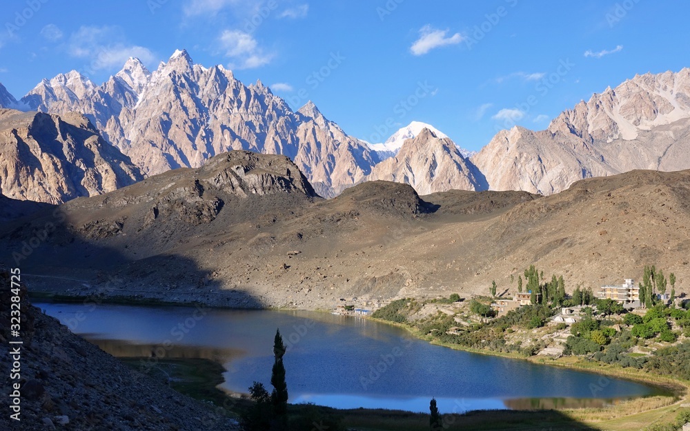 The warm Borith Lake with the Passu cones peaks in the background - Trekking in Pakistan 2019