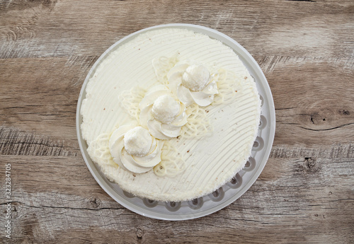 tasty  white cake with cream on a wooden background. View from above.