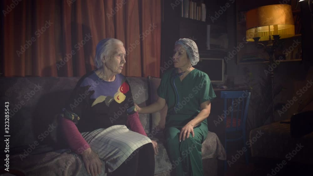 Medical care for grandmother at home. A health worker comes to an elderly woman's home and is interested in her state of health. Medical care for grandmother at home. A health worker comes to an elderly woman's home and is interested in her state of health.