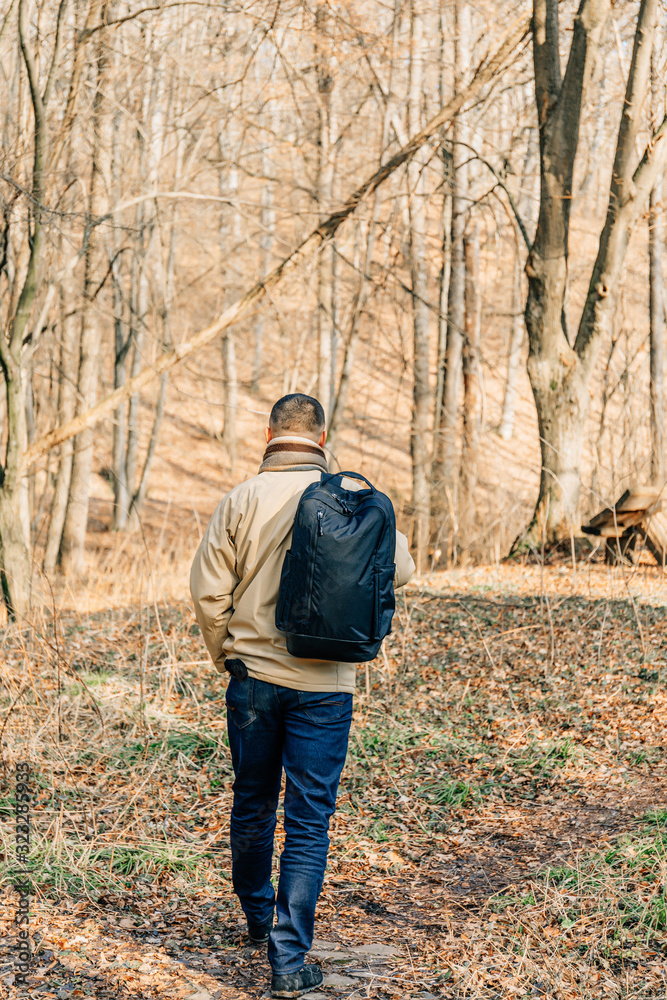 Young handsome man with autumn tree in background. Handsome man in the park. Autumn scenery Young handsome man with autumn tree in background. Handsome man in the park. Autumn scenery