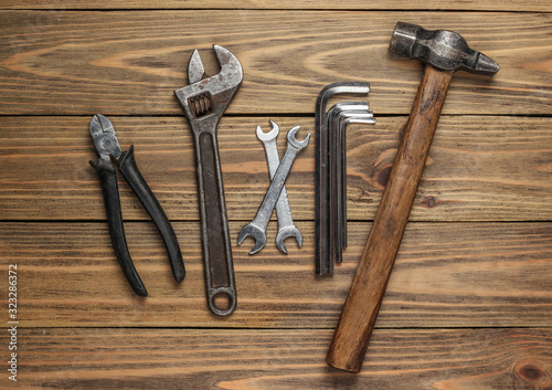 Set of professional work tools on wooden background. Top view.