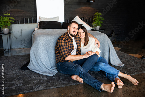 Attractive couple in a loft bedroom at home
