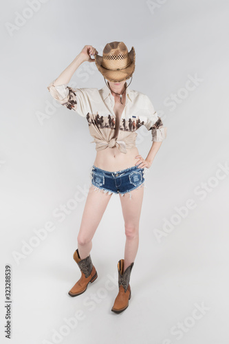a country girl without face in cowboy leather boots and a cowboy hat covering her face on a white background
