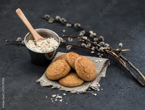 Shortbread oatmeal cookies with milk on a dark gray background