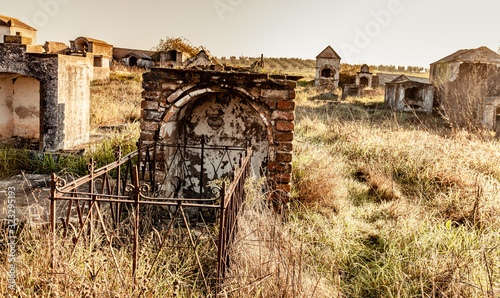 Abandoned  ruin  cemetery  and overgrown landscape