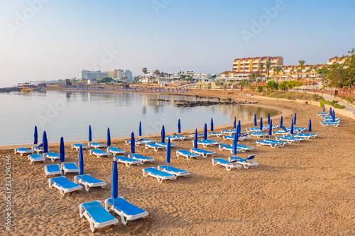 Cyprus. Protaras. Sun loungers on the beach of Protarass city. Hotels near the beach in Cyprus. Beach in Cyprus. Place for sunbathing. Resorts of the Mediterranean Sea. Travel to Protaras. © Grispb