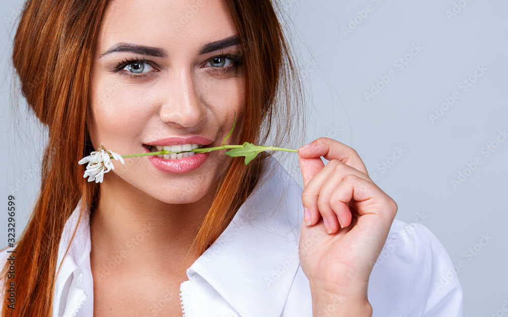 Delicate flower in the mouth of a beautiful girl Delicate flower in the mouth of a beautiful girl