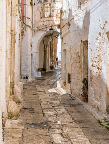 Fototapeta Naklejka Na Ścianę i Meble -  Scenic sight in Ostuni on a sunny summer day, Apulia (Puglia), southern Italy. 