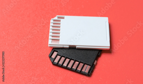 Two Mini SD memory cards on pink background close up