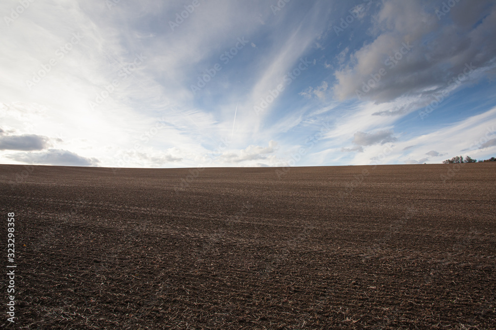 Plowed field prepared for planting crops at sunset Plowed field prepared for planting crops at sunset