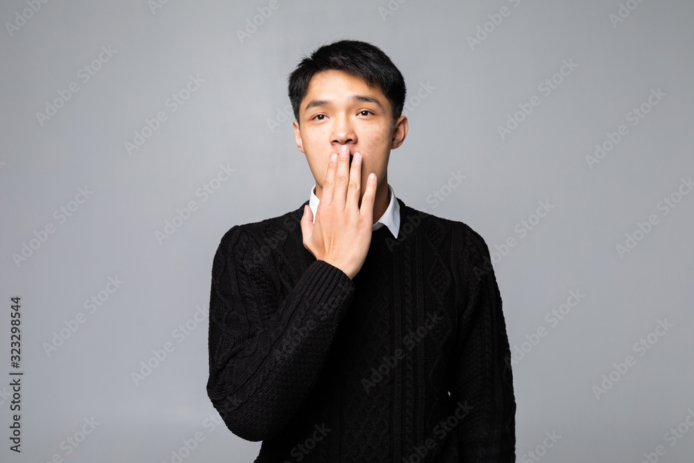Young chinese man shocked covering mouth with hands for mistake standing over isolated white background. Secret concept. Young chinese man shocked covering mouth with hands for mistake standing over isolated white background. Secret concept.