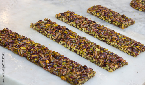 Pistachio nut sweet bars on the stone table, Mediterranean sweets. photo