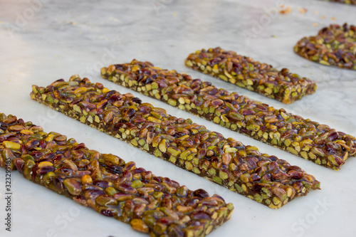 Pistachio nut sweet bars on the stone table, Mediterranean sweets.