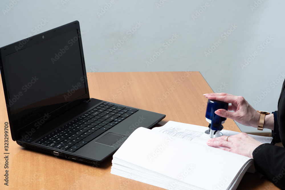 The accountant checks the financial report. The accountant stamp The accountant checks the financial report. The accountant stamp