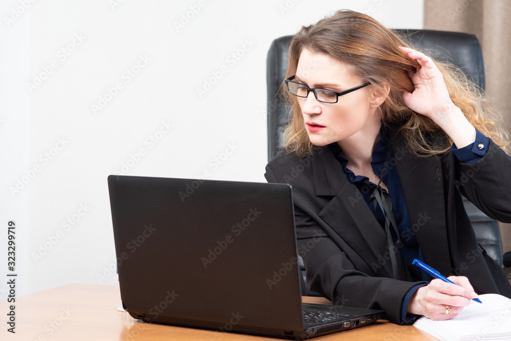 Girl works with a laptop. Accountant fills out a report. Woman s Girl works with a laptop. Accountant fills out a report. Woman s