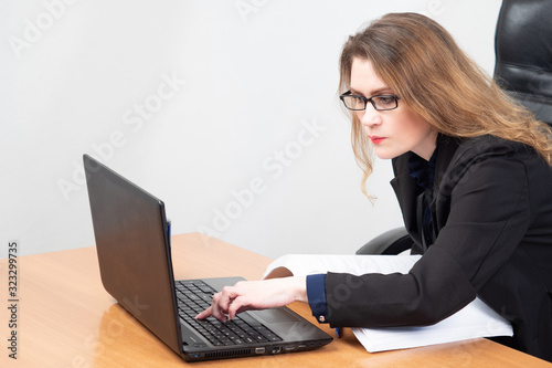 Woman is passionate about working with a laptop. Girl is looking