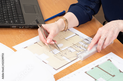 A man works with blueprints...