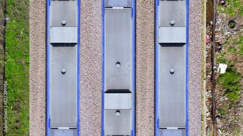 Three passenger Trains synchronised crossing at high speed in opposite directions, Top down aerial duplications. photo