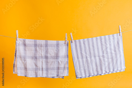 Towel drying after washing isolated on a yellow