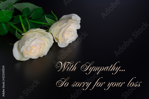 Photo our deepest condolences message  white  flowers black background