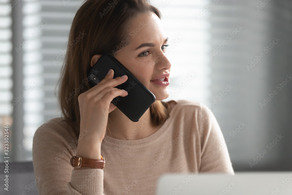 Close up of female employee talk on smartphone in office