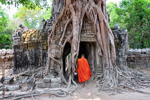 Ta Som temple with a monk in complex Angkor Wat. photo