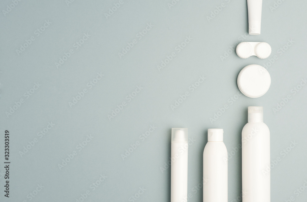 plane collection of various beauty hygiene containers on soft gray background. Space to fill.top view . plane collection of various beauty hygiene containers on soft gray background. Space to fill.top view .