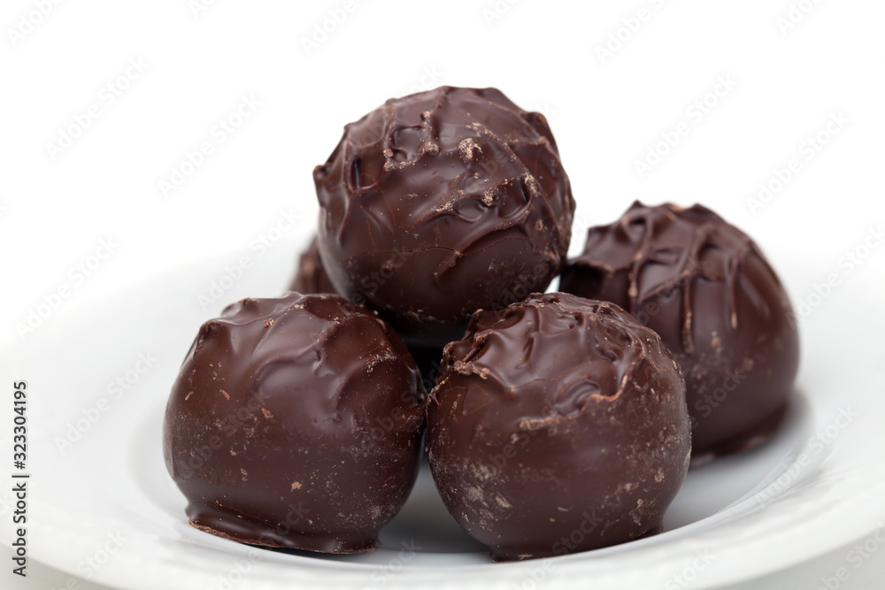 Dark chocolate truffles on a plate Dark chocolate truffles on a plate