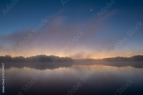 Moonrise, Whitford Lake in fog, Fort Custer State Park, Michigan, USA