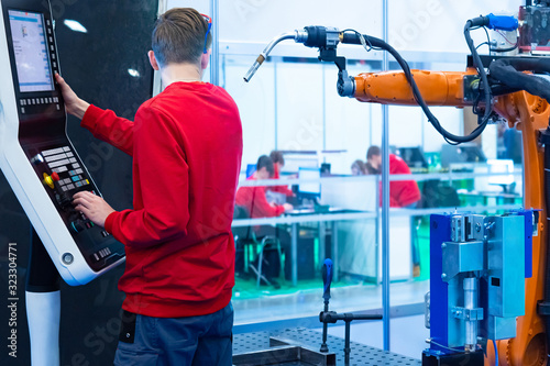 Robotics. A man in a red sw...