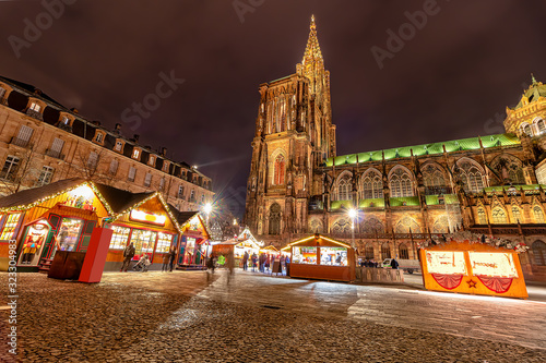 Long exposure photography of Christmas Market near Cathedral in the city of Strasbourg at night, Alsace region, France