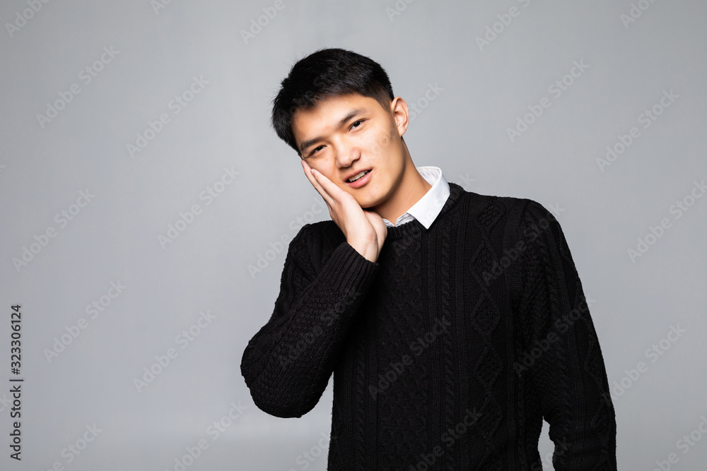 Portrait of fat Asian man use his hand touch his cheek, feeling painful from toothache. Oral health concept. Portrait of fat Asian man use his hand touch his cheek, feeling painful from toothache. Oral health concept.